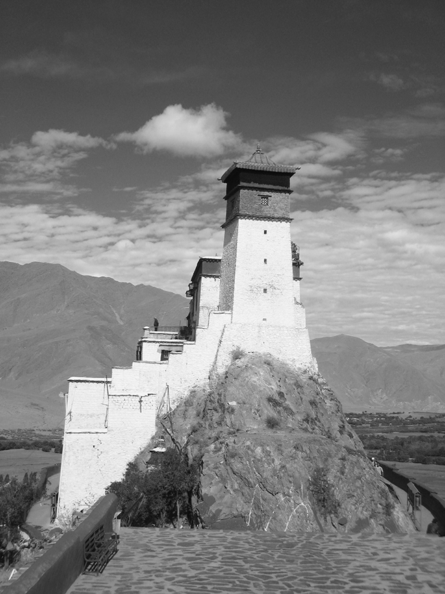 Yumbulagang, also known as Yumbu Lakhang or Yungbulakang Palace) is an ancient palace in the Yarlung Valley, Nêdong County in the vicinity of Zêtang the seat of the prefectural administration of Lhoka, in the South of Tibet.
According to legend it was the first building in Tibet and the palace of the first Tibetan king, Nyatri Tsenpo. Yungbulakang stands on a hill on the eastern bank of the Yarlung River in the Yarlung Valley of southeast Naidong County, about 192 km southeast of Lhasa, and 9 km south of Tsetang. According to a legend of followers of the Bön religion, Yumbulagang was erected in the second century B.C. for the first Tibetan king Nyatri Tsenpo, descended from the sky. During the reign of the 28th king, Lha Thothori Nyantsen, in the fifth century, a golden Stupa, a jewel (and/or a form to the manufacture of dough-Stupas) and a Sutra that no one could read fell from the sky on the roof of Yumbulagang; a voice from the sky announced: 'in five generations one shall come, that understands its meaning!' Later, Yumbulagang became the summer palace of the 33rd king Songtsen Gampo and princess Wencheng. After Songtsen Gampo had transferred his seat to Lhasa, Yumbulagang became a shrine and under the reign of the 5th Dalai Lama, Ngawang Lobsang Gyatso, a monastery of the Gelugpa school.